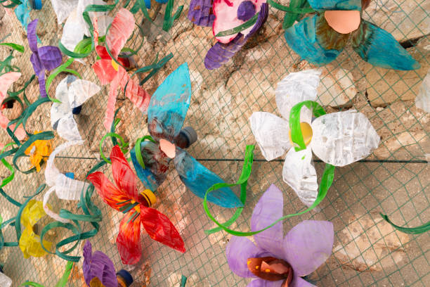 Flower wall decoration with plastic bottles made from plastic waste. Concept: Waste recycling and environmental protection