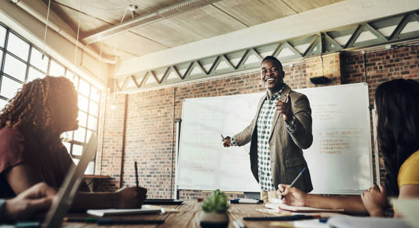 istock Business people, discussion and presentation with white board in meeting for training, coaching and onboarding for career growth. Group, interactive and conversation for learning, workshop and skills 2156200494