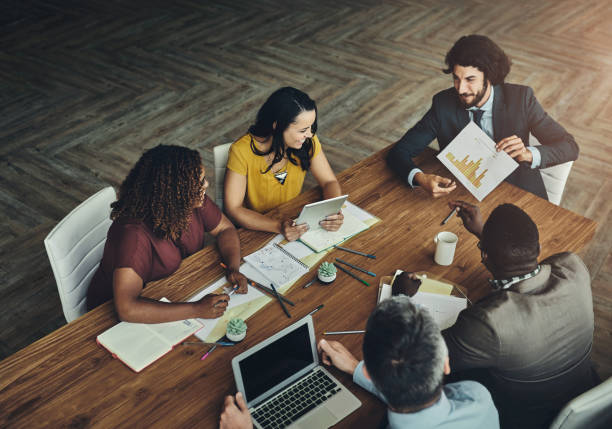 istock Business people, documents and meeting with discussion for brainstorming, planning or collaboration above at office. Top view of group or employees discussing paperwork, statistics or corporate data 2156200499