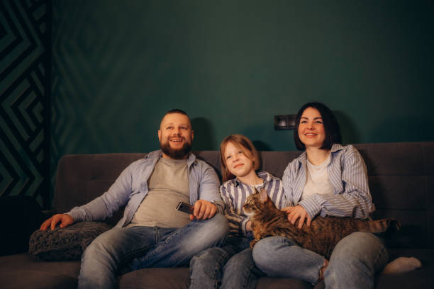 istock Family watching movie on sofa at night 2156200565