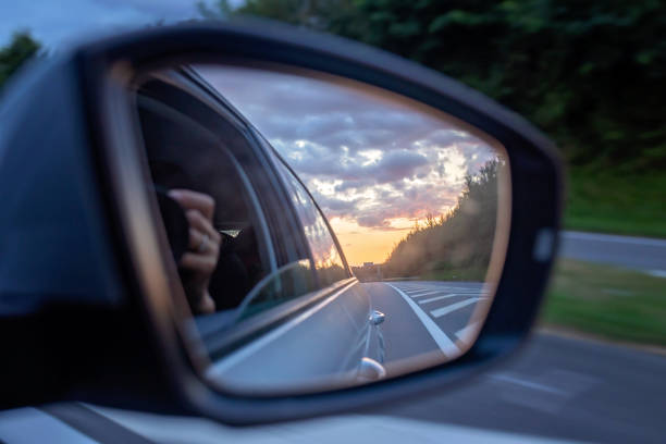 istock Sunset in car mirror, reflection from the nature 2156201936