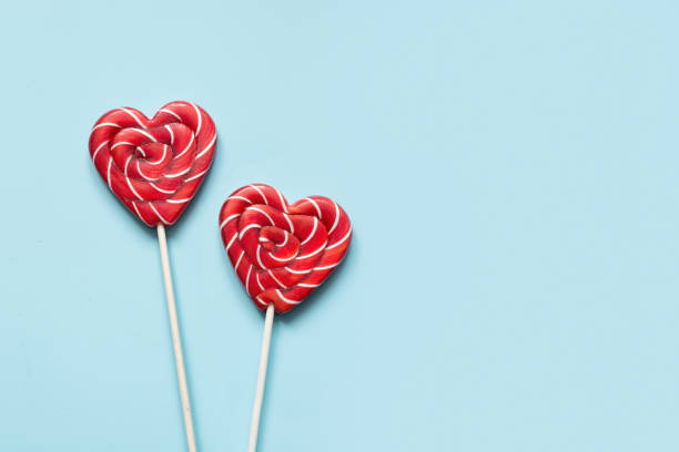 istock Valentine's card. Lollipops candy as heart on blue. Funny concept. 2156203346