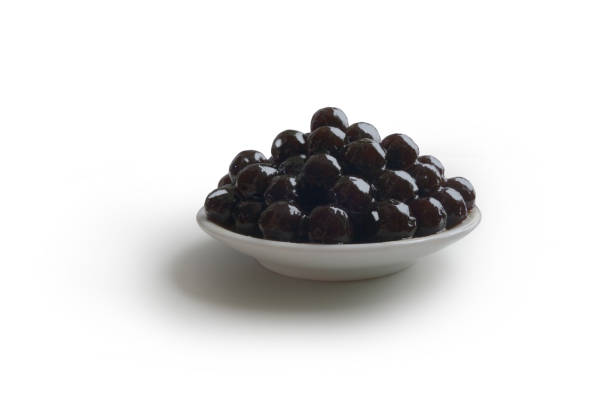 istock Black tapioca Taiwan pearls, raw boba bubble tea popping ball on white background 2156203903