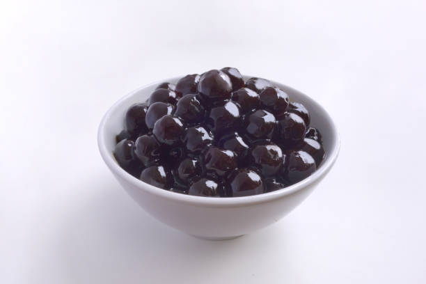 Black tapioca Taiwan pearls, raw boba bubble tea popping ball on white background