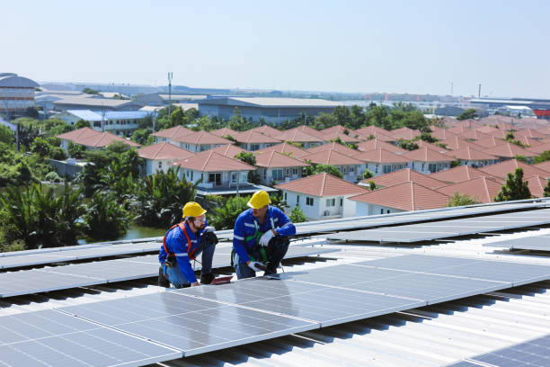 istock Two caucasian engineers discussing about checking for problems with solar panels on factory roofs. 2156204174