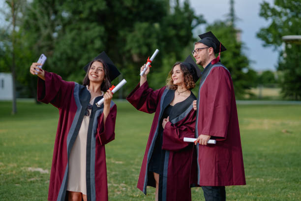 istock Group of college students  taking photograph on graduation day. 2156209926