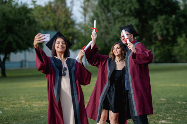 istock Group of college students  taking photograph on graduation day. 2156210063
