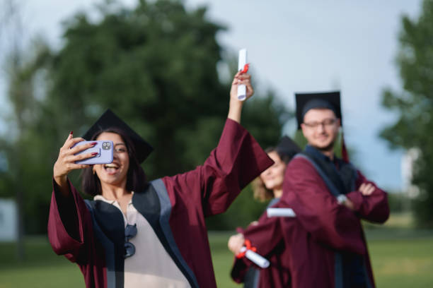 istock Group of college students  taking photograph on graduation day. 2156210149