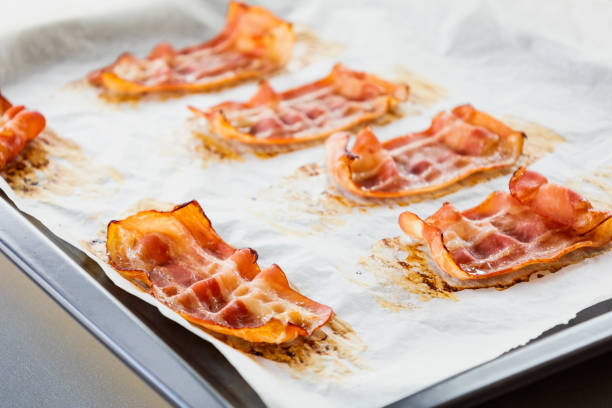 Baked Bacon Strips on Parchment Paper Close-Up