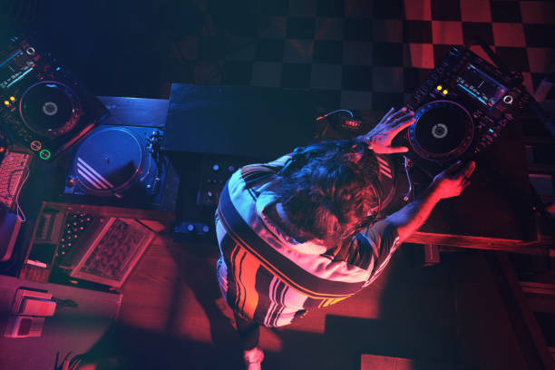 istock Anonymous DJ performing music in dark club 2156214916