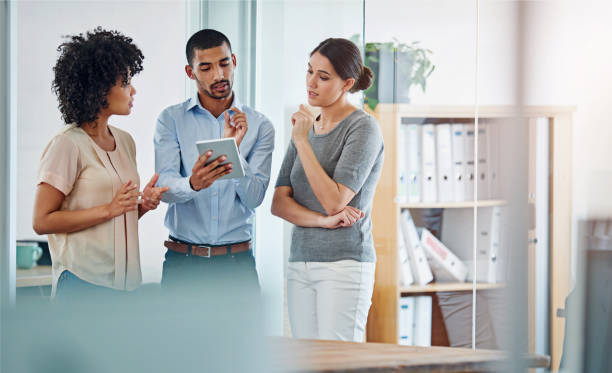 istock Planning, team and people in office with tablet for collaboration or business networking with technology. Workplace, employees and corporate digital project with group for ideas in the Netherlands. 2156216520