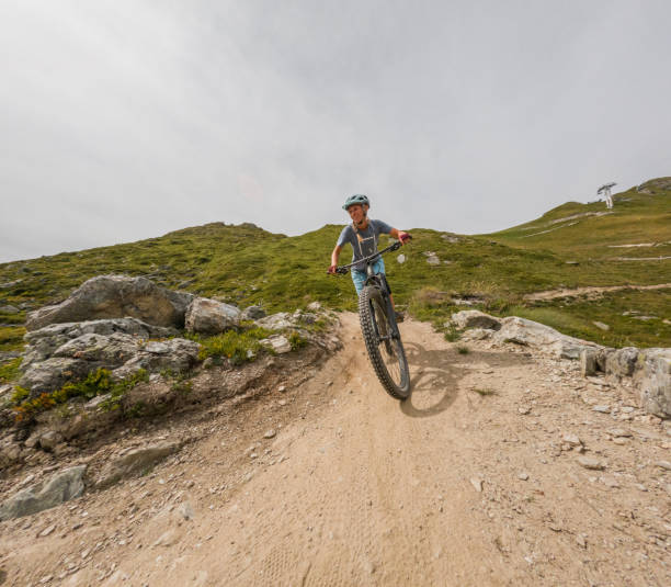 istock Grit and Grind: Mountain Biker Tackling an Uphill Rocky Trail 2156216972