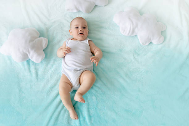 istock baby on a blue sky background with clouds laughing 2156217006