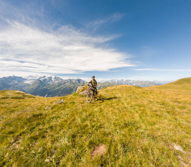 istock Mountain Biker Enjoying Sunny Alpine Meadow 2156217104