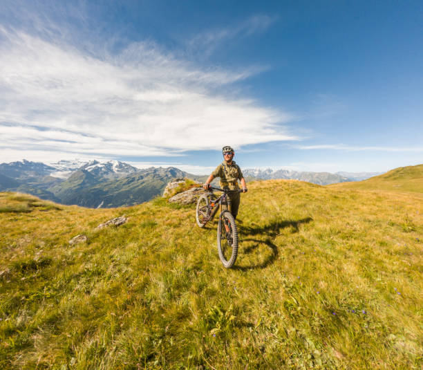 istock Mountain Biker Enjoying Sunny Alpine Meadow 2156217109