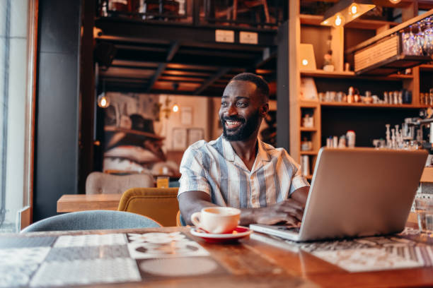 istock Man sitting in coffee shop and using laptop 2156220619
