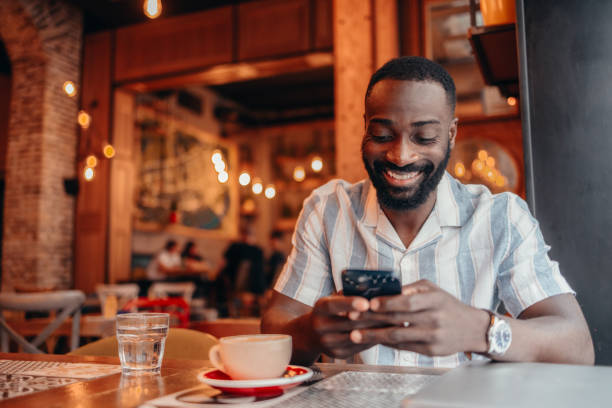 istock Man sitting in coffee shop and using mobile phone 2156220659