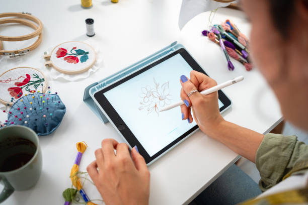 istock A young seamstress designs an embroidery with the help of a tablet 2156220694