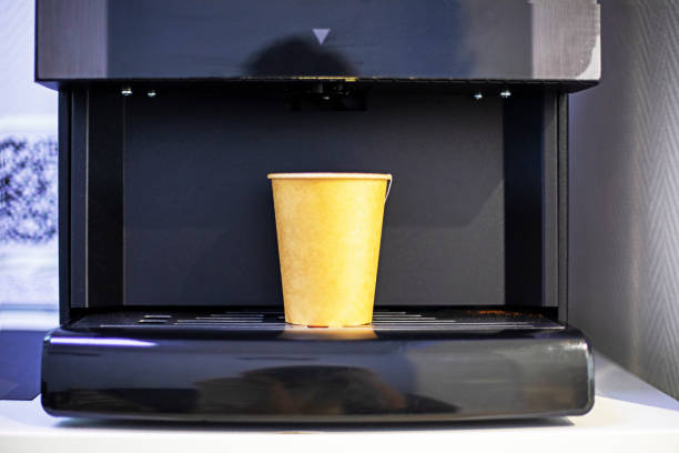 istock vending machine with a disposable, recyclable cardboard cup containing a hot drink. Ecology of the environment 2156221443