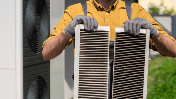 istock Man with gloves holding two clogged air filters from a home ventilation system. 2156221831