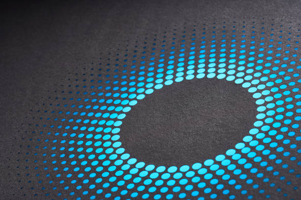 istock Abstract cut paper art featuring a circular pattern of blue dots in a radial design on a dark textured background. 2156221883