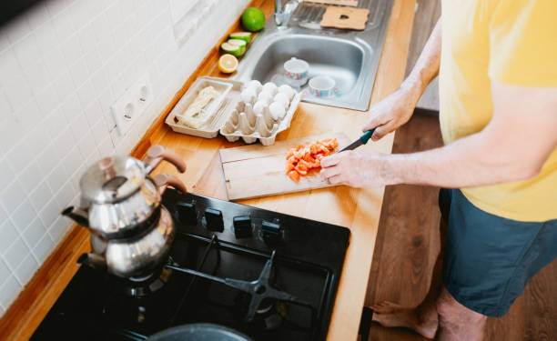 istock Cooking healthy breakfast: cutting fresh tomatoes 2156225287