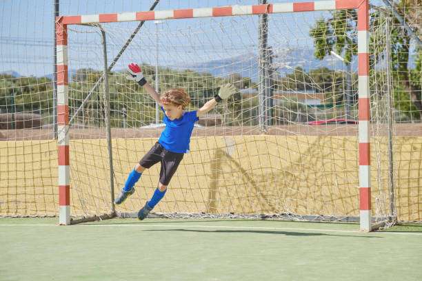 istock Boy catching ball at football goal 2156227796
