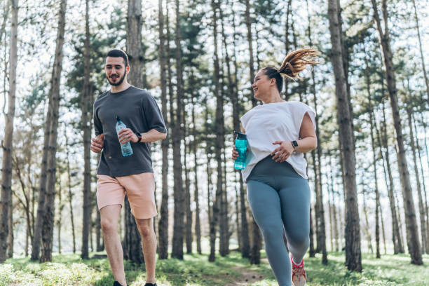 istock Couple jogging at the park 2156231533