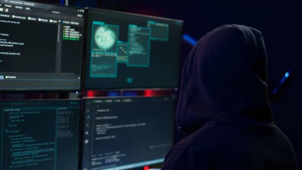 istock Close up of hacker running code in apartment on PC monitors 2156231760