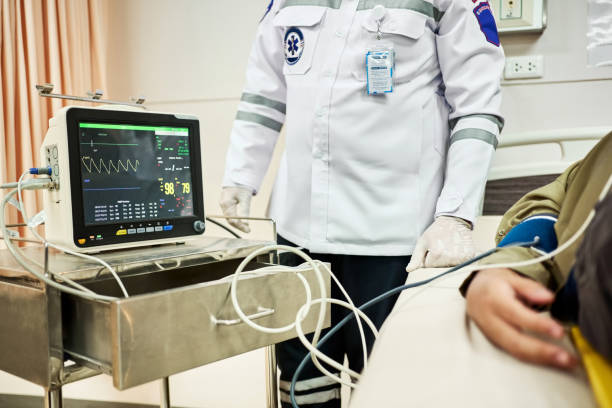 paramedics-monitoring-vitals-of-serious-patient-on-ecg-monitor.jpg?b=1&s=612x612&w=0&k=20&c=HETRhq3C8qFyZPwUQbx1UXKotM0T_FjqufOlhXPkCFI=