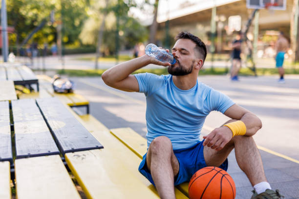 istock Basketball athlete hydrating on sunny day 2156233631