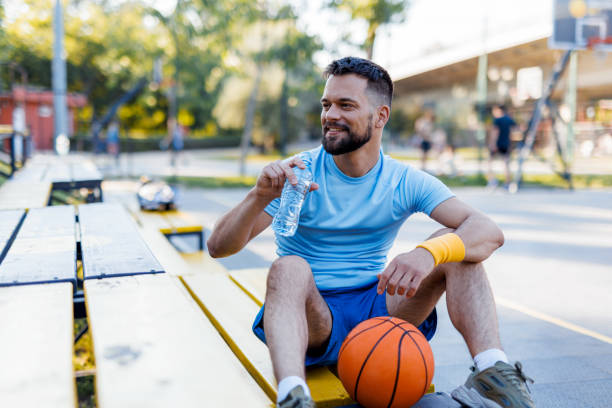 istock Smiling man holding bottle and basketball 2156233633