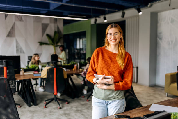 istock Beautiful young woman in office space 2156235338