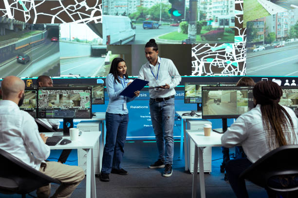 istock Indian team of operators instructing their colleagues to use CCTV surveillance 2156240412