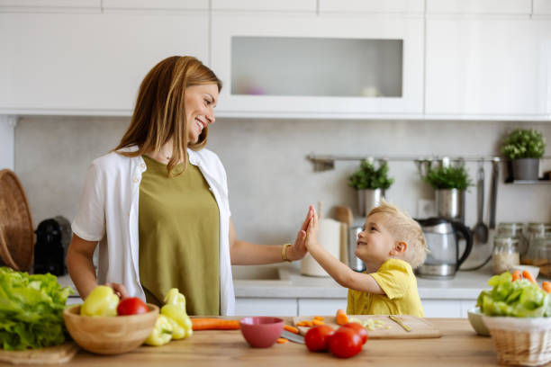 istock Little Boy Give High Five Gesture to His Mother 2156240429