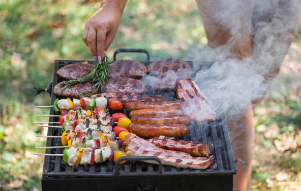 istock Young woman preparing barbecue in the backyard 2156241340