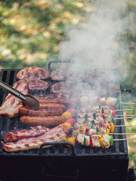 istock Young woman preparing barbecue in the backyard 2156241346