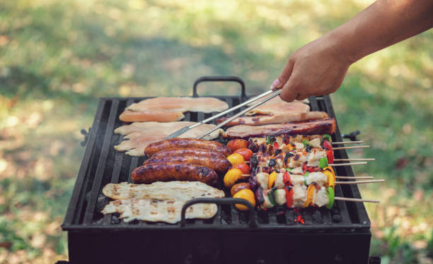 istock Young woman preparing barbecue in the backyard 2156241356