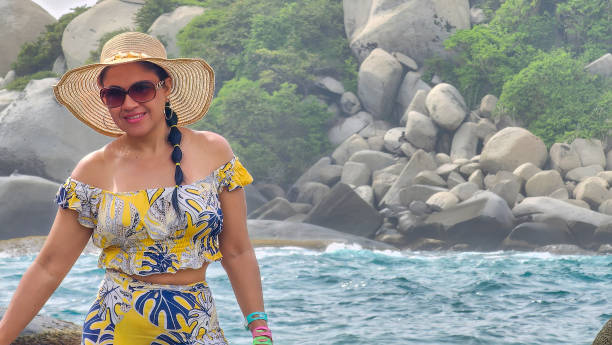 istock Female tourist visiting a beautiful beach 2156241723