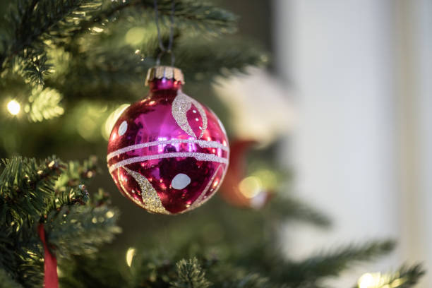 istock Christmas ornaments hanging from a christmas tree.. 2156243424