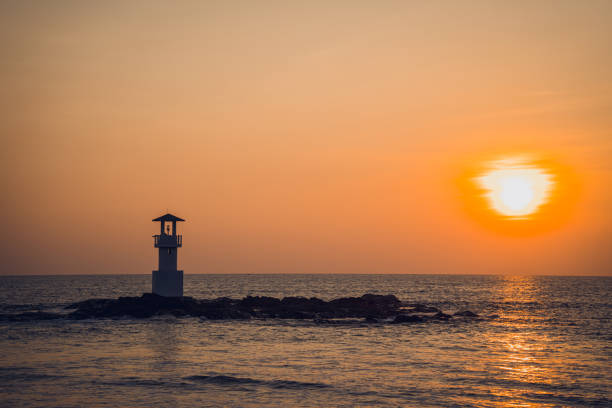 istock A lighthouse in the ocean during a beautiful sunset 2156244676