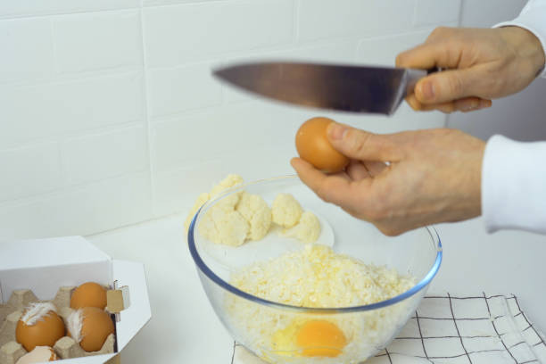 istock Person Holding Knife Over Bowl of Eggs 2156245280