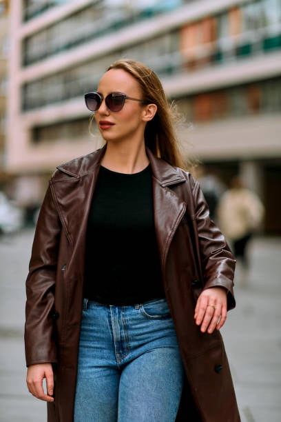 istock Stylish Woman Strolls the Streets with Confidence 2156250798