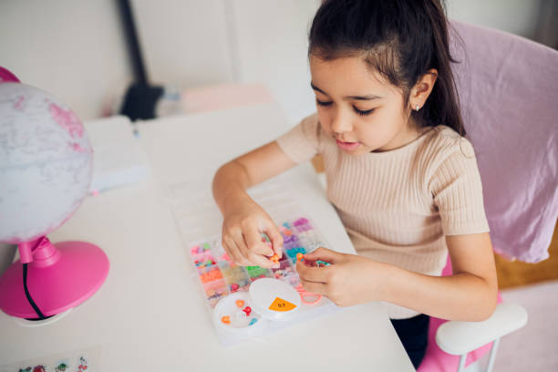 Young girl playing with beads