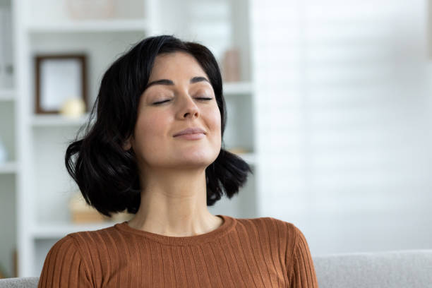 istock Woman with closed eyes practicing mindfulness and relaxation at home 2156255331