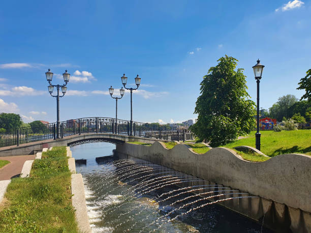 istock Small pedestrian bridge on city pond embankment 2156258749