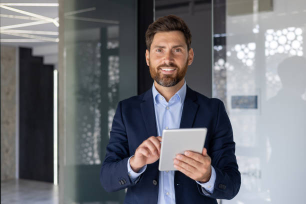 istock Confident businessman with tablet in modern office 2156258853