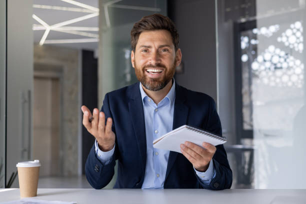 istock Confident businessman in office setting discussing ideas 2156259509