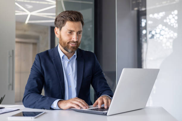istock Professional businessman working on laptop in modern office 2156260738