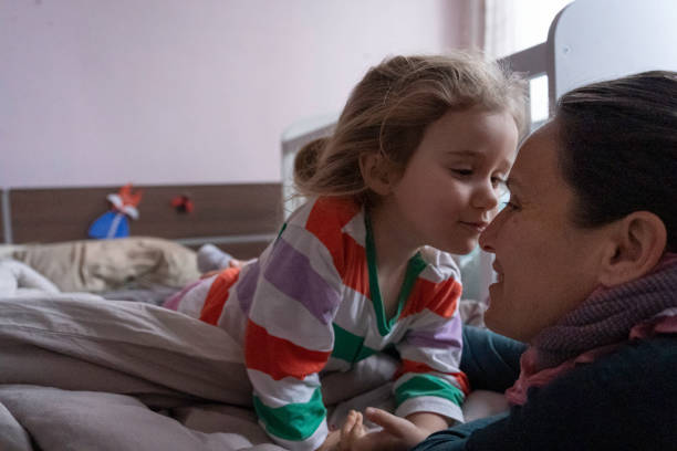 istock Early Wake Up. Kiss for Mom in Bed. 2156261795